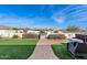 Spacious backyard with pool, patio, and manicured lawn, ideal for outdoor activities at 19612 W Georgia Ave, Litchfield Park, AZ 85340