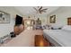 Large bedroom featuring a TV, barn door, shelving, and carpeted floor at 19612 W Georgia Ave, Litchfield Park, AZ 85340