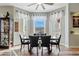 Bright dining area with large bay windows, modern lighting, and a view of the outdoors at 19612 W Georgia Ave, Litchfield Park, AZ 85340