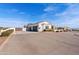 Single story home with a three car garage, concrete tile roof and low maintenance landscape at 19612 W Georgia Ave, Litchfield Park, AZ 85340
