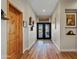 Inviting foyer features wood floors and a striking wood door, enhancing the home's character at 19612 W Georgia Ave, Litchfield Park, AZ 85340