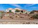 Inviting front exterior with desert landscaping, a circular driveway and white stucco with a red tile roof at 19612 W Georgia Ave, Litchfield Park, AZ 85340