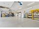 Spacious three car garage with abundant shelving, workbench and multiple refrigerators at 19612 W Georgia Ave, Litchfield Park, AZ 85340