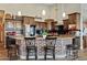 Spacious kitchen with stainless steel appliances, wooden cabinets, and a brick-accented breakfast bar at 19612 W Georgia Ave, Litchfield Park, AZ 85340