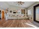 Spacious living room with modern furniture, wood-look flooring, and ample natural light at 19612 W Georgia Ave, Litchfield Park, AZ 85340