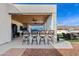 Outdoor bar featuring covered wood ceiling, barstools and backyard mountain views at 19612 W Georgia Ave, Litchfield Park, AZ 85340