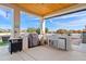Outdoor kitchen with stainless steel appliances, built-in grill and decorative lighting at 19612 W Georgia Ave, Litchfield Park, AZ 85340