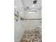 Modern shower featuring elegant tile, a shower bench, and updated fixtures at 19612 W Georgia Ave, Litchfield Park, AZ 85340