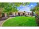 This back yard is spacious and has a lush green lawn and covered patio at 20218 N 61St Ave, Glendale, AZ 85308