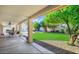 This back yard has a beautiful lawn, lush landscaping, and a covered patio at 20218 N 61St Ave, Glendale, AZ 85308