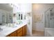 Bright bathroom features double sink vanity and separate tub and shower at 20218 N 61St Ave, Glendale, AZ 85308