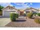 Charming single-story home with a well-maintained front yard and two-car garage, showcasing great curb appeal at 20218 N 61St Ave, Glendale, AZ 85308