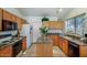 Functional kitchen with wood cabinets, granite countertops, and stainless steel appliances, creating a warm and inviting space at 20218 N 61St Ave, Glendale, AZ 85308