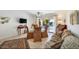 Comfortable living space with tile flooring, glass dining table, plush seating, and sliding glass doors to the backyard at 20218 N 61St Ave, Glendale, AZ 85308