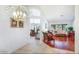 Spacious entryway to the house, with tile flooring, leads to the living and dining area with wood floors at 20218 N 61St Ave, Glendale, AZ 85308