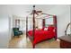 Inviting main bedroom with a four-poster bed, tiled floors, and cozy seating area at 20218 N 61St Ave, Glendale, AZ 85308