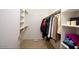 Organized walk-in closet with shelving and ample hanging space for clothes and accessories at 20218 N 61St Ave, Glendale, AZ 85308