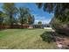 A sprawling green backyard with lush grass, mature trees, privacy fence, and covered patio area at 2121 S Ventura Dr, Tempe, AZ 85282