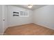 Bright bedroom with wood laminate floors, neutral walls, decorative floating shelves and a window at 2121 S Ventura Dr, Tempe, AZ 85282