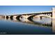 Scenic view of a multiple-arch bridge spanning over calm water, showcasing its architectural design against the sky at 2121 S Ventura Dr, Tempe, AZ 85282