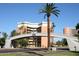 View of an ASU building on a sunny day, featuring a pedestrian bridge with ASU signage and a tall palm tree at 2121 S Ventura Dr, Tempe, AZ 85282
