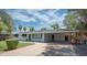 Inviting single-story home showcasing a covered parking area and lush front yard at 2121 S Ventura Dr, Tempe, AZ 85282