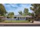 Charming single-story home featuring well-maintained landscaping and a covered parking area at 2121 S Ventura Dr, Tempe, AZ 85282