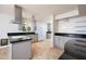 Modern kitchen featuring stainless steel appliances, gray cabinets, and granite countertops at 2121 S Ventura Dr, Tempe, AZ 85282