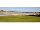 Lakeside park view with lush green grass, a serene lake, and recreational amenities in the distance at 2121 S Ventura Dr, Tempe, AZ 85282