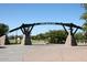 Tempe Beach Park entrance features a decorative steel structure and stone pillars with well-maintained greenery at 2121 S Ventura Dr, Tempe, AZ 85282