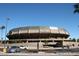 Wide angle shot of Wells Fargo Arena featuring parking spaces, desert landscaping, and the circular architectural style at 2121 S Ventura Dr, Tempe, AZ 85282