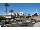 Exterior view of the Sun Devil Stadium with visible parking, signage, and palm trees on a clear day at 2121 S Ventura Dr, Tempe, AZ 85282