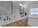 Elegant bathroom featuring double sinks with marble countertop and modern fixtures at 2312 N Raven --, Mesa, AZ 85207