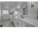 Bright bathroom with dual sinks, stylish mirrors, vanity area, marble countertops, and modern light fixtures at 2312 N Raven --, Mesa, AZ 85207