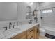 Stylish bathroom with a double sink vanity featuring marble countertops, plus modern fixtures at 2312 N Raven --, Mesa, AZ 85207