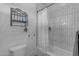 Clean bathroom showcasing a shower with white tiled walls and a convenient storage rack at 2312 N Raven --, Mesa, AZ 85207