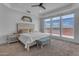 Serene bedroom featuring a large window with scenic views, plush carpet, and tray ceiling with ceiling fan at 2312 N Raven --, Mesa, AZ 85207