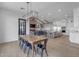 Open-concept dining room with a wooden table, kitchen with an island, brick fireplace and beam ceilings at 2312 N Raven --, Mesa, AZ 85207