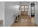 Bright foyer features hardwood floors, console table and double doors leading to a view of the front yard at 2312 N Raven --, Mesa, AZ 85207