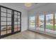 Bright home office features modern glass doors, large windows with exterior views and hardwood flooring at 2312 N Raven --, Mesa, AZ 85207