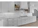 White cabinetry, marble countertops, and gold hardware accent this modern kitchen at 2312 N Raven --, Mesa, AZ 85207