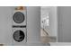 Modern laundry room features new appliances, white walls, and a doorway leading to the bathroom at 2312 N Raven --, Mesa, AZ 85207