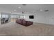 Spacious living room with plush carpet, a large sectional, and balcony access at 2312 N Raven --, Mesa, AZ 85207