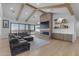 Spacious living room boasts exposed wood beams, large windows, and a brick fireplace with flatscreen TV at 2312 N Raven --, Mesa, AZ 85207