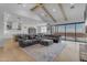 Expansive living room features an open floor plan with a large sectional and views of the outdoor scenery at 2312 N Raven --, Mesa, AZ 85207