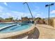 Community pool with beautiful rock waterfall feature, in-pool spa and nearby lounge area at 2312 N Raven --, Mesa, AZ 85207