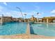 Community pool with rock waterfall feature, in-pool spa, and covered outdoor dining area at 2312 N Raven --, Mesa, AZ 85207