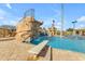 Community pool boasts diving board, rock waterfall feature, and crystal clear water at 2312 N Raven --, Mesa, AZ 85207
