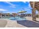 Community pool features lounge chairs, shade umbrellas, and a rock waterfall feature at 2312 N Raven --, Mesa, AZ 85207