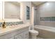 Well-lit bathroom featuring a modern vanity, blue accent tiles, and a shower-tub combination at 2366 E Shea Blvd, Phoenix, AZ 85028